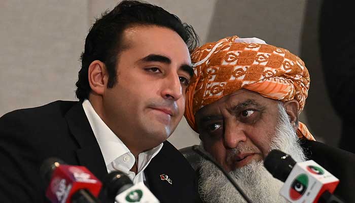 PPP Chairman Bilawal Bhutto-Zardari (left) listens to PDM chief Maulana Fazlur Rehman during a press conference in Islamabad on July 25, 2022. — AFP