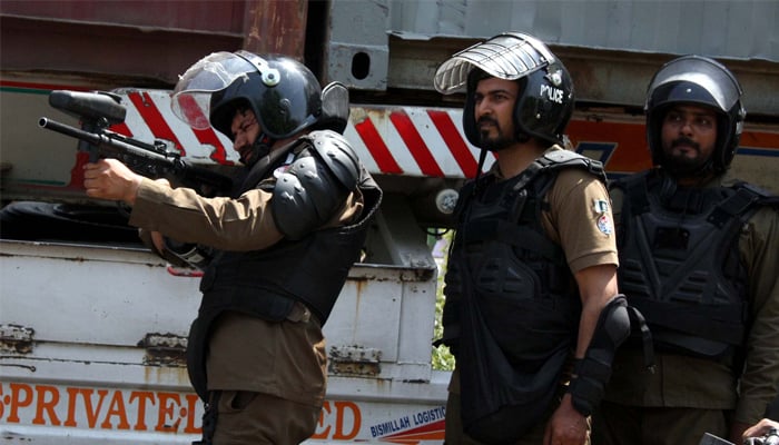 Punjab Police Personnel try to repel protesters during a clash between Police and violent protesters against the arrest of PTI Chief Imran Khan from the premises of Islamabad High Court, at Mall road in Lahore on May 10, 2023.