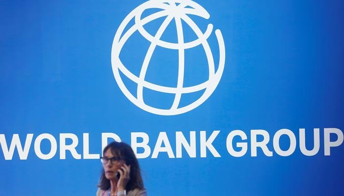 A participant stands near a logo of World Bank at the International Monetary Fund — World Bank Annual Meeting 2018 in Nusa Dua, Bali, Indonesia, October 12, 2018. — Reuters