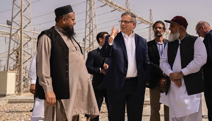 US Ambassador Donald Blome speaks to a power plant official during his visit. — Provided by US Embassy