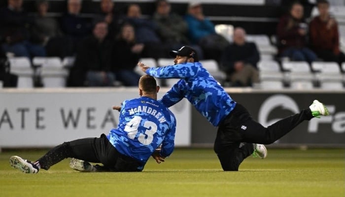 Shadab Khan (right) seen while colliding with Nathan McAndrew while trying to take a catch between Sussex and Somerset on May 26, 2023. — AFP