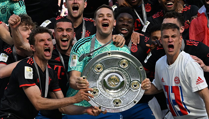 Bayern Munich´s German goalkeeper Manuel Neuer celebrates with the trophy after the German first division Bundesliga football match between FC Cologne and FC Bayern Munich in Cologne, western Germany on May 27, 2023.—AFP