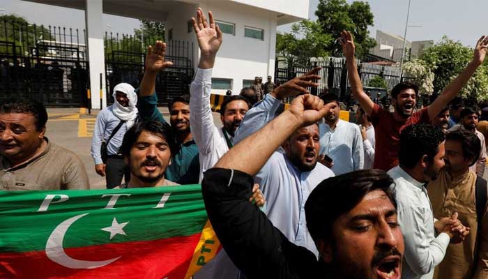 Supporters of the Pakistan Tehreek-e-Insaf (PTI) chant slogans in support of Imran Khan, outside the parliament building in Islamabad, April 3, 2022. — Reuters