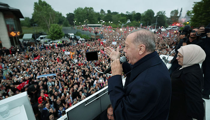 This handout photograph taken and released by the Turkish Presidency Press Office on May 28, 2023 shows Turkish President Recep Tayyip Erdogan addressing supporters gathered outside his residence following his victory in Turkish presidential election at Kisikli district in Istanbul. AFP