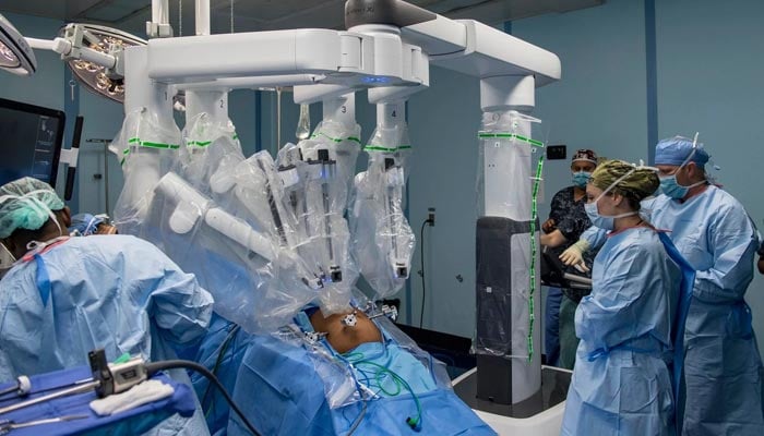 An undated image of a team of doctors performing a robotic surgery. — Photo by author