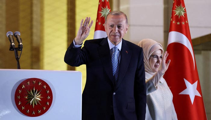 Turkish President Tayyip Erdogan and his wife Ermine Erdogan wave as he addresses his supporters following his victory in the second round of the presidential election at the Presidential Palace in Ankara, Turkey May 28, 2023. — Reuters