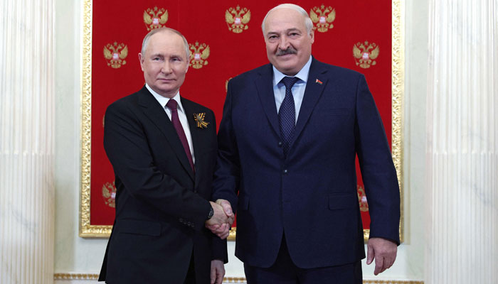 Russian President Vladimir Putin greets Belarus President Alexander Lukashenko at the Kremlin prior to the Victory Day military parade in central Moscow on May 9, 2023. — AFP