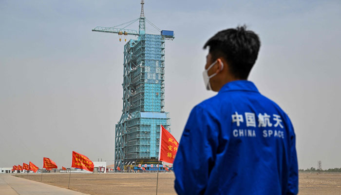 A member from the China space program stands before the launch platform of the Shenzhou-16 Manned Space Flight Mission on May 29, 2023. — AFP
