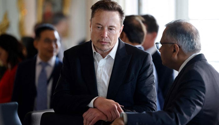 Tesla CEO Elon Musk looks on among other CEOs before a roundtable during the 6th edition of the Choose France Summit at the Chateau de Versailles, outside Paris on May 15, 2023. — AFP