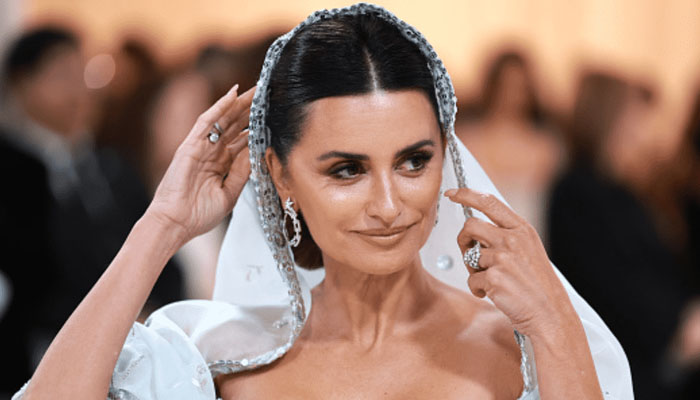 Penelope Cruz wore a green mini dress while shooting a commercial at a flower stall on the streets of Madrid