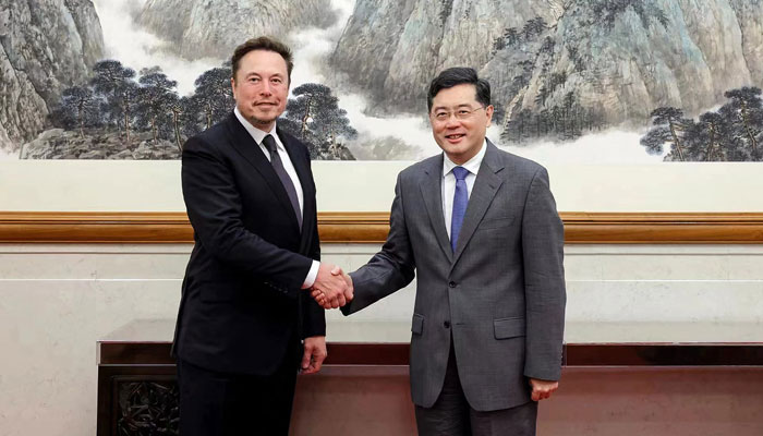 This picture on May 30, 2023, shows Tesla CEO Elon Musk (L) shaking hands with Chinas Foreign Minister Qin Gang during a meeting in Beijing. — AFP
