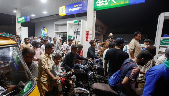 People wait for their turn to get fuel at a petrol station in Peshawar, Pakistan January 30, 2023. — Reuters