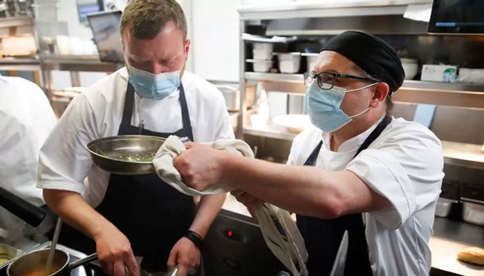 A representational image of restaurant workers busy preparing food. — Reuters/File