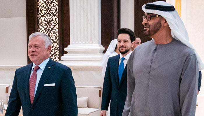 The picture shows UAE President Sheikh Mohamed bin Zayed al-Nahyan (R) receiving King Abdullah II of Jordan (L) and his son Crown Prince Hussein, at Abu Dhabis presidential airport on April 18, 2023. — AFP