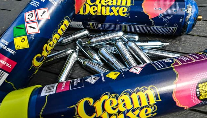 Capsules of nitrous oxide, also called laughing gas, are displayed on a table. — AFP/File