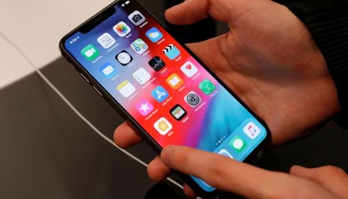 A customer tests a smartphone during the launch of the new iPhone XS and XS Max sales at re: Store Apple reseller shop in Moscow, Russia.—Reuters