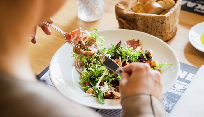 A representational image of a person eating food. — Unsplash/File