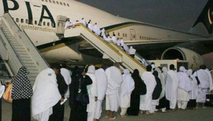 Intending pilgrims embark on a Pakistan International Airline’s plane in this undated photo. — APP