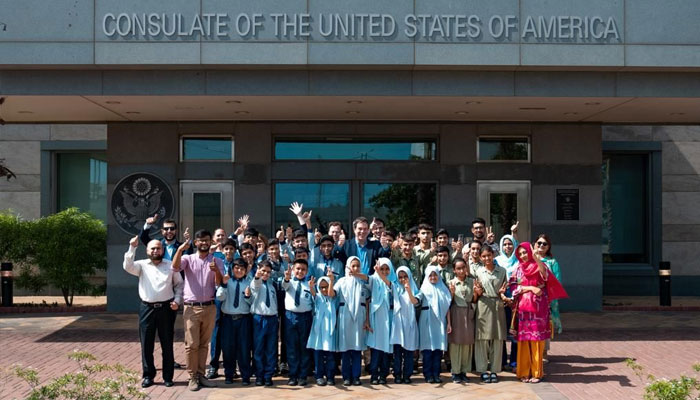 United States Deputy Chief of Mission (DCM) in Pakistan Andrew Schofer with a group of school children. — Press Release