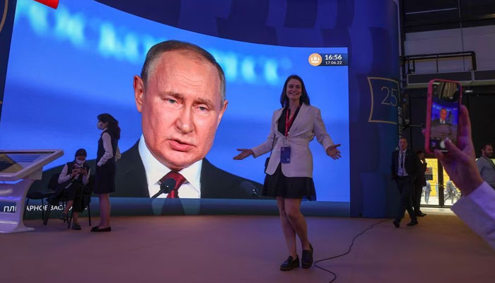 Participants gather near a screen showing Russian President Vladimir Putin, who delivers a speech at the St. Petersburg International Economic Forum (SPIEF) in Saint Petersburg, Russia June 17, 2022.—Reuters