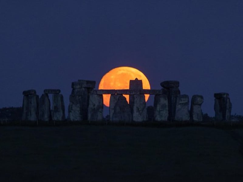 The nearly full Strawberry Moon setting at Stonehenge. — Twitter@ST0NEHENGE