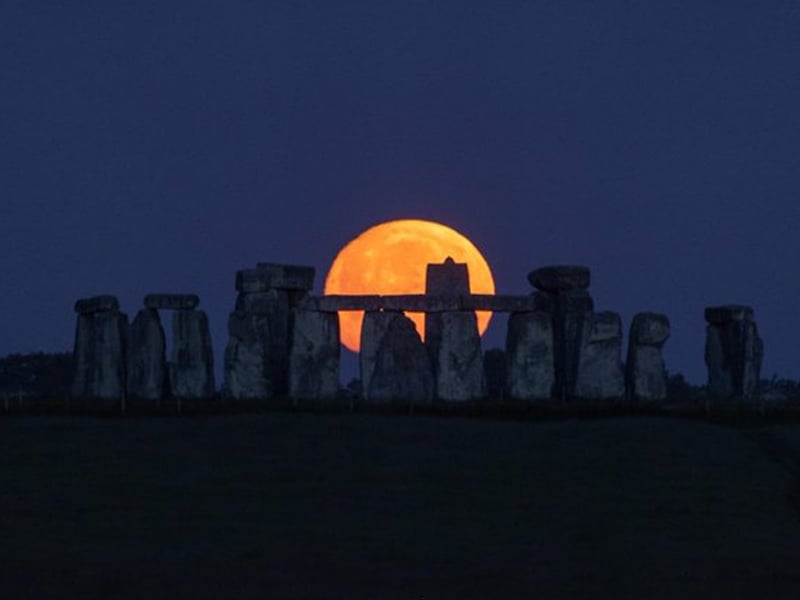 The nearly full Strawberry Moon setting at Stonehenge. — TwitterST0NEHENGE