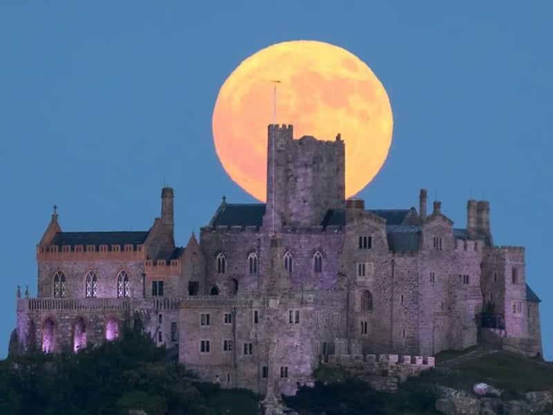 Strawberry Full Moon rising behind St Michaels Mount in Cornwall. — Twitter/@stucornell