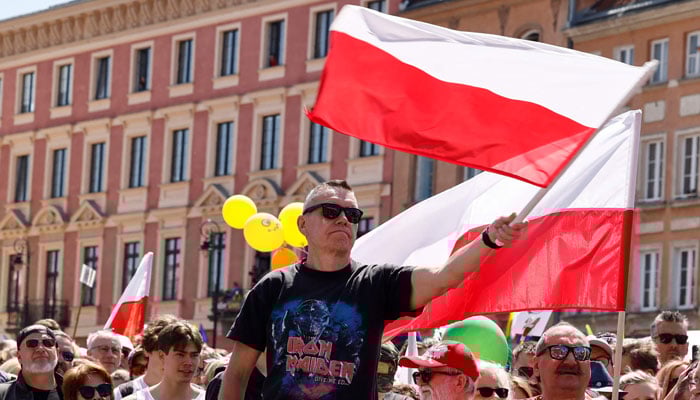 Protesters wave the Polish flag during an anti-government demonstration organized by the opposition in Warsaw on June 4, 2023. — AFP