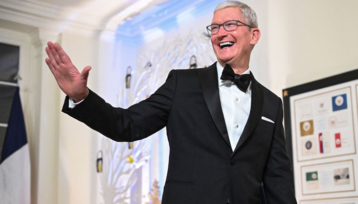 Chief Executive Officer of Apple Tim Cook (L) arrives at the White House to attend a state dinner honouring French President Emmanuel Macron, in Washington, DC. — AFP/File