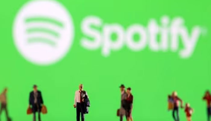 Small figurines are seen in front of the displayed Spotify logo in this illustration taken February 11, 2022.—Reuters