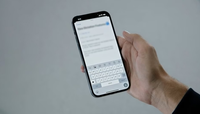A mans hand is seen holding an iPhone while typing something. — Apple website/File