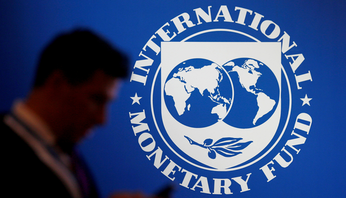 A participant stands near a logo of IMF at the International Monetary Fund - World Bank Annual Meeting 2018 in Nusa Dua, Bali, Indonesia, October 12, 2018. — Reuters