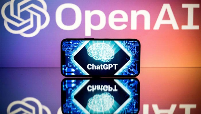 A mobile screen showing the ChatGPT logo and OpenAI behind the other screen. — AFP/File