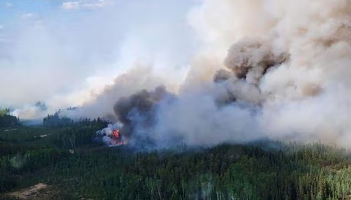 Smoke rises above the southeast perimeter of the Paskwa fire as it burns near Fox Lake, Alberta, Canada May 16, 2023.—Reuters