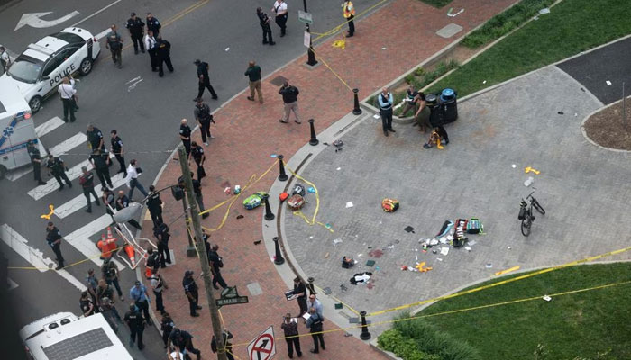 Law enforcement officers investigate the scene after a shooting in a park as high school graduates emerged from a theatre where commencement exercises had just concluded, in Richmond, Virginia, US on June 6, 2023. — Reuters