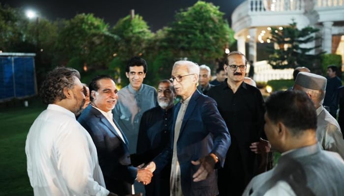 Jahangir Tareen (centre) greets ex-PTI members at Aleem Khans residence in Lahore on June 7, 2023. Twitter/SHABAZGIL