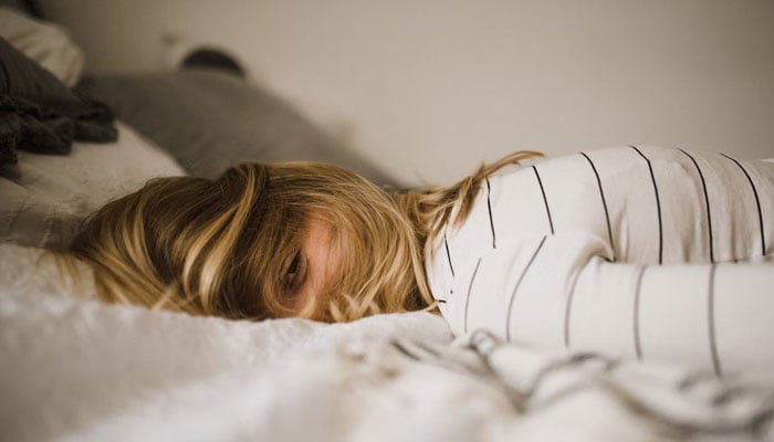 A representational image of a girl having trouble falling sleep. — Unsplash/File