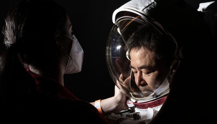 Astronaut Akihiko Hoshide, of the Japanese Aerospace Exploration Agency, suits up for a photo shoot ahead of his 2021 launch to the International Space Station, a mission that lasted around six months.—NASA