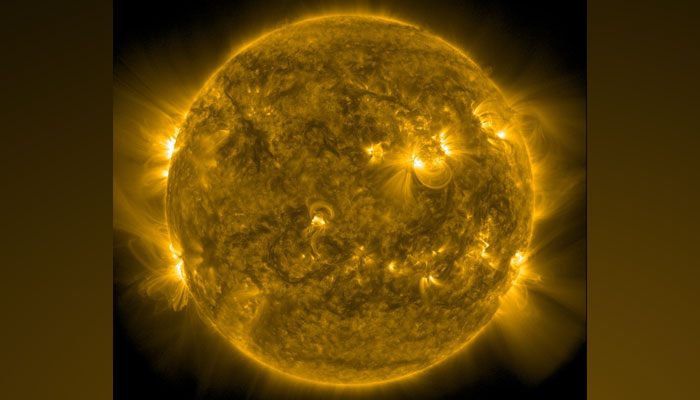 The Sun, colored in yellow on a black background shows several brighter spots visible on the surface. — Twitter/NasaSun/File