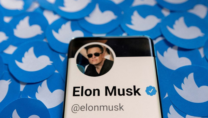 Elon Musks Twitter profile is seen on a smartphone placed on printed Twitter logos in this picture illustration taken April 28, 2022. — Reuters