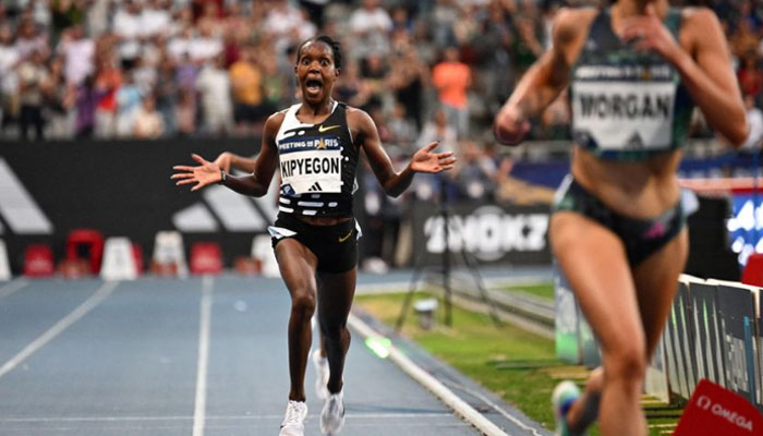 Kenyan athlete Faith Kipyegon reacts as she breaks the world record in the womens 5000m event during the IAAF Diamond League Meeting de Paris athletics meeting at Charlety Stadium. AFP