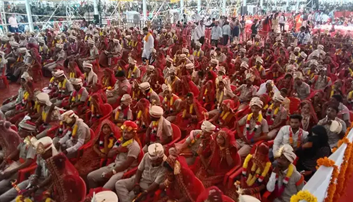 Numerous couples sitting at the venue of mass wedding. — Guinness World Record