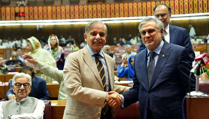 Prime Minister Shehbaz Sharif shakes hands with Minister for Finance and Revenue Ishaq Dar after the budget speech 2023-24 at the National Assembly in Islamabad on Friday, June 9, 2023. — PPI