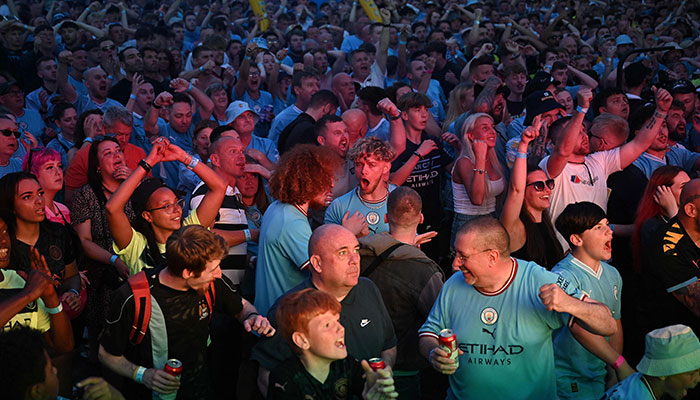 Manchester City fans celebrate the opening goal as they watch the UEFA Champions League final football match between Manchester City and Inter Milan in Istanbul at 4TheFans Fan Park in Manchester, northern England, on June 10, 2023.—AFP