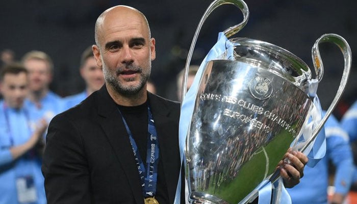Pep Guardiola, the manager of Manchester City expressing joy holding the trophy after the club won Champions League final. Twitter
