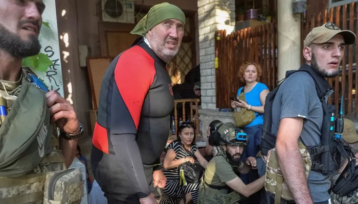 Rescuers react to Russian shelling during evacuation efforts of those trapped by flooding in Kherson region