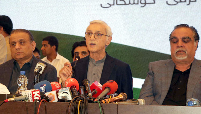 Jahangir Khan Tareen addresses media persons during a press conference alongside Aleem Khan and several PTI defectors in Lahore on June 8, 2023. — PPI