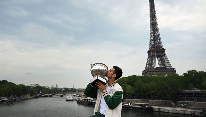 Novak Djokovic kisses the Trophy during a photocall after winning the Roland-Garros French Open tennis tournament, in Paris, on June 12, 2023. — AFP