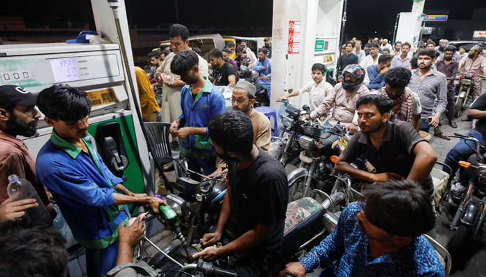 People wait their turn to get fuel at a petrol station, in Karachi, Pakistan June 2, 2022. — Reuters