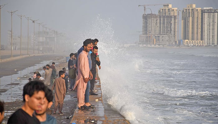 People enjoy high tide waves in the Arabian Sea at Sea View in Karachi on July 12, 2023. — Online/File